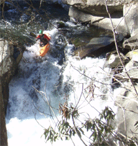 Kayaker going over the falls at The Sinks